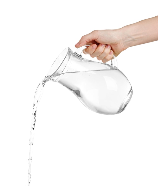 Versare acqua da una brocca di vetro isolata su bianco