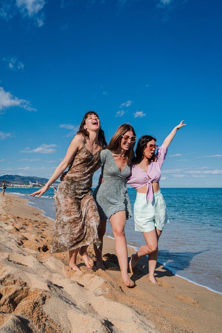 Vertical group of only women walking along the beach enjoying their summer vacation on the coast