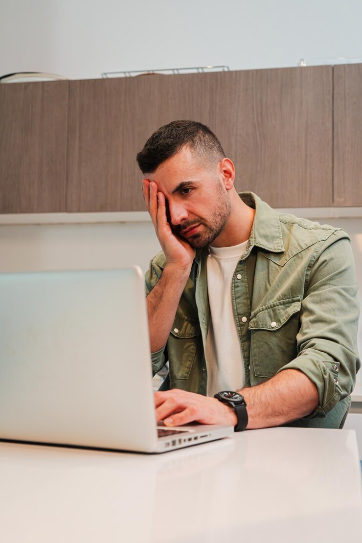 Vertical hard working man desperate due to laptop issues causing her stress and headaches a