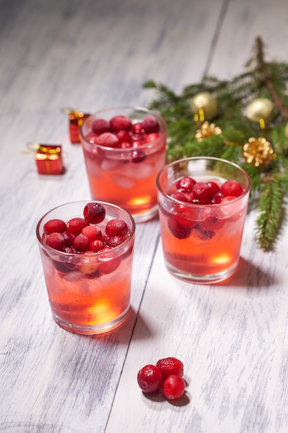 Vetri con succo di mirtillo rosso su legno bianco