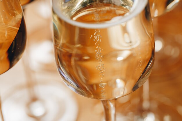 Vetri di Champagne sul primo piano della tavola.