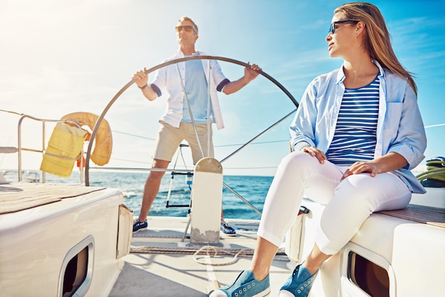 Viaggi rilassati e lusso con coppia su yacht per amore estivo e tramonto durante il viaggio di vacanza a Roma Viaggio avventuroso e uomo e donna che navigano in barca per l'oceano tropicale e luna di miele in mare