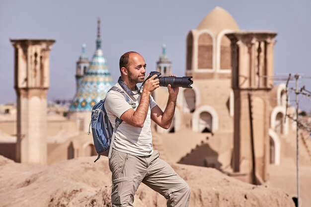 Viaggiatore singolo fa foto nella città vecchia durante un viaggio individuale indipendente, Kashan, Iran.