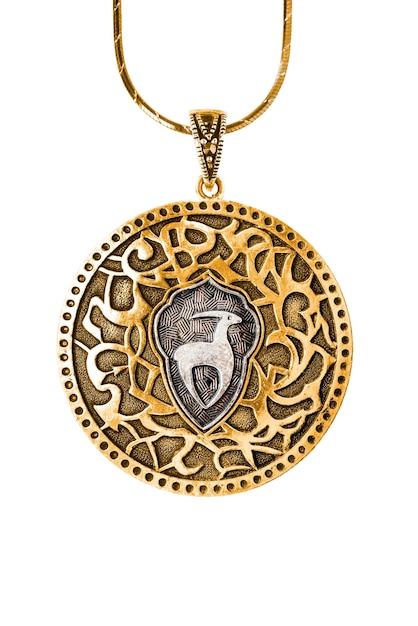 Vintage ethnic gold pendant hanging on a chain on white background