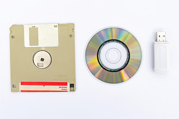 vintage retro electronic data storage External memory in Computer Organization devices from 80s 90s cd disk flash drives Stack floppy disks selective focus