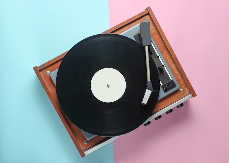 Vinyl player on blue pink pastel. Top View
