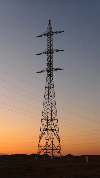 Vista a bassa angolazione della silhouette del pilone elettrico contro un cielo limpido durante il tramonto