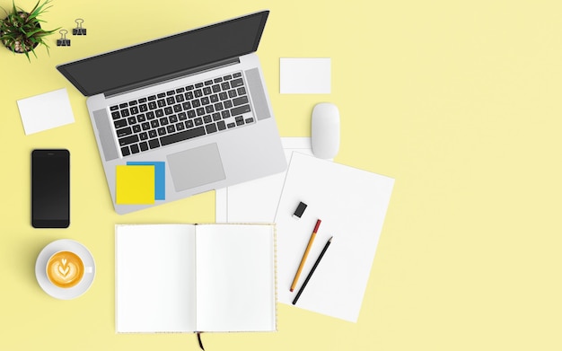 Vista ad alta angolazione del portatile con caffè e forniture per ufficio sullo sfondo giallo