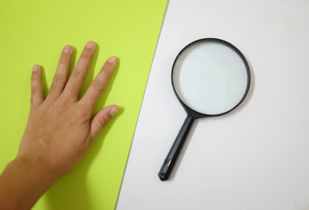 Vista ad alto angolo di una mano umana che tiene una tazza su uno sfondo bianco