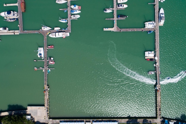 Vista aerea dall'alto verso il basso Drone colpo di yacht e barca a vela parcheggio nel porto turistico Trasporto e sfondo di viaggio Bellissimo mare nella stagione estiva