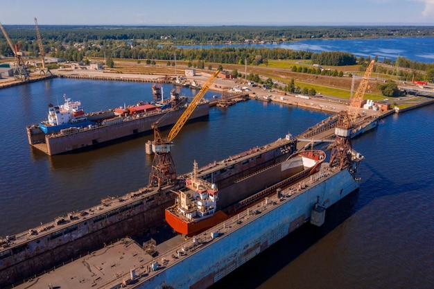 Vista aerea della nave nel bacino di carenaggio galleggiante in riparazione mediante sabbiatura a Riga, Lettonia.