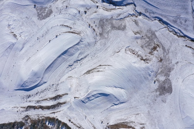 Vista aerea delle terrazze di campagna coperte di neve nelle montagne