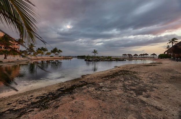 Vista dal fondo della spiaggia di Puerto Aventuras in Messico durante il crepuscolo