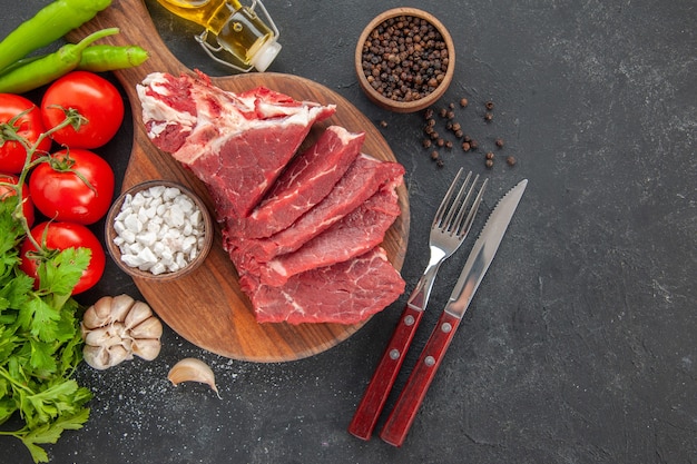 vista dall'alto carne fresca a fette con pomodori e verdure?