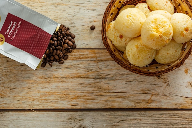 Vista dall'alto del cheesebread brasiliano o 'pao de queijo' con chicchi di caffè sopra lo spazio della copia del tavolo