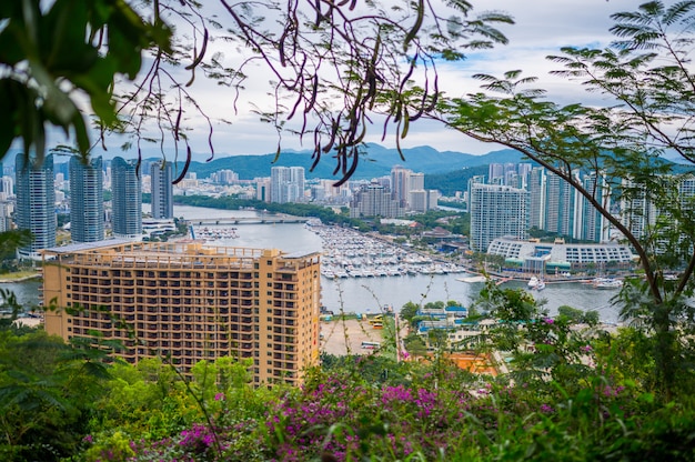 Vista dall'alto della città di Sanya di Hainan, con case locali e hotel ed edifici di lusso. Paradiso delle vacanze estive in Asia.