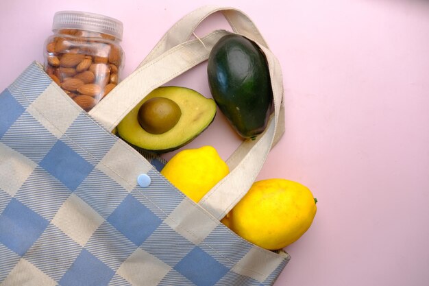 Vista dall'alto della fetta della borsa della spesa di avocado, limone e mandorla sul tavolo