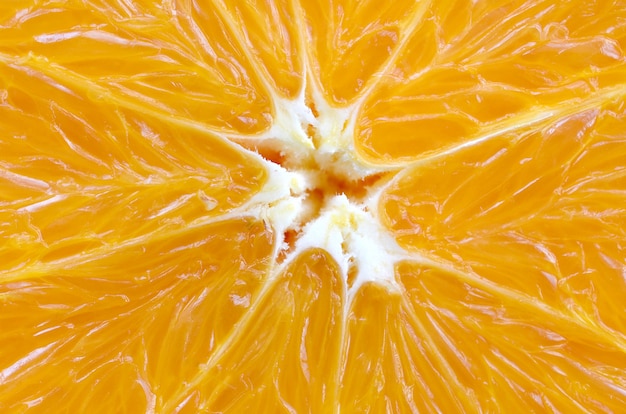 Vista dall&#39;alto di un frammento della fetta di frutta arancione da vicino. Macro trama di sfondo