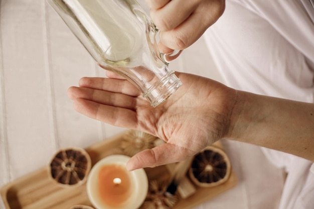 Vista dall'alto di una donna che usa un olio per il corpo per spa