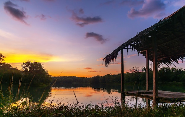 Vista del tramonto o dell'alba del cielo drammatico colorato con sfondo di nuvole sul fiume dell'acqua nella foresta, cielo con nuvole in natura e concetto di viaggio.