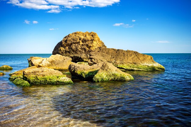 Vista della bella scogliera enorme colorata e del mare sul retro