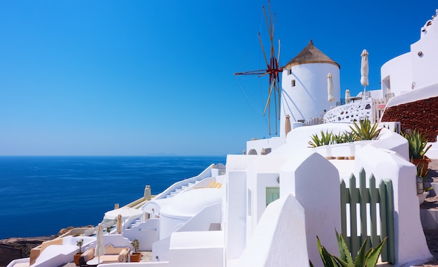 Vista della città di Oia nell'isola di Santorini con vecchie case imbiancate e mulino a vento, Grecia -- paesaggio greco