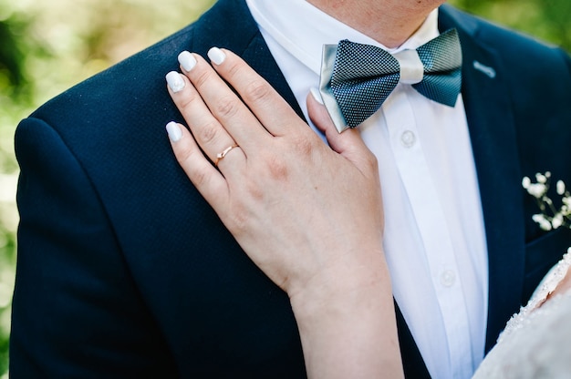 Vista delle mani con fedi nuziali. Giorno del matrimonio.