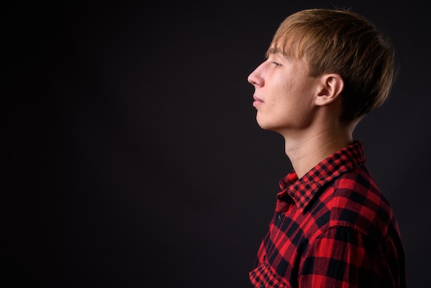 Vista di profilo di giovane uomo bello con capelli biondi