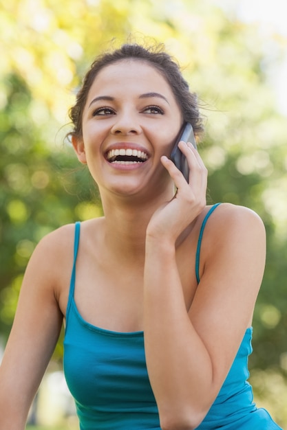 Vista frontale della giovane donna carina telefonando