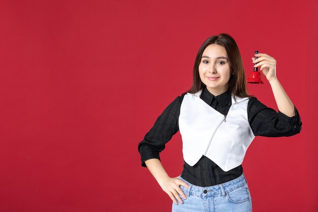 vista frontale giovane cameriera in uniforme con campanella su sfondo rosso cena colore sera lavoro lavoro donna bellezza lavoratore ristorante cafe