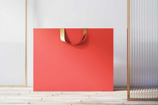 Vista frontale su shopping bag di carta rossa vuota con posto per il tuo marchio o testo su pavimento in legno chiaro e sfondo muro chiaro primo piano rendering 3D mock up