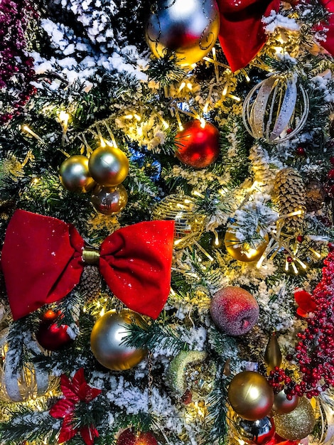 Vista ingrandita dell'albero di Natale completamente decorato e illuminato. Foto di auguri di Natale. Noel. Sfondo di ghirlanda di luci. Buon anno. Vista frontale. Foto di alta qualità.