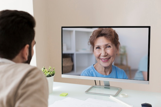 Vista laterale dell'uomo che effettua una videochiamata