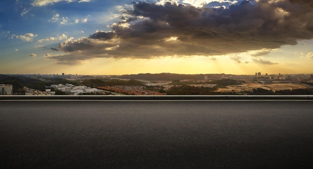 Vista panoramica del lato della strada asfaltata con l'ora d'oro del tramonto nuvoloso di colore blu e arancione drammatico