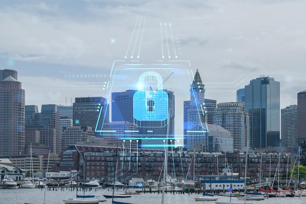 Vista panoramica sulla città del porto di Boston durante il giorno Massachusetts Edifici esterni del centro finanziario Ologramma del lucchetto luminoso Concetto di sicurezza informatica per proteggere le informazioni riservate