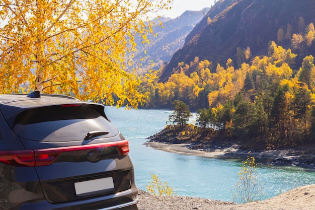 Vista posteriore dell'auto nera parcheggiata nell'area di sosta o sullo sfondo del fiume blu della montagna della strada panoramica