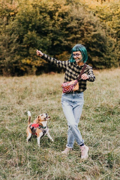 Vista posteriore di una ragazza con un cane sul campo
