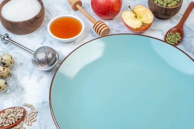 Vista ravvicinata del piatto blu vuoto e degli ingredienti per il cibo sano su sfondo di ghiaccio