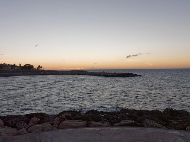 Vista sul mare e sui sassi sulla spiaggia di Pedregalejo al tramonto