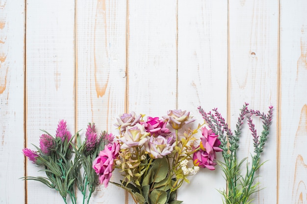 Vista superiore dei fiori di nozze su fondo di legno bianco