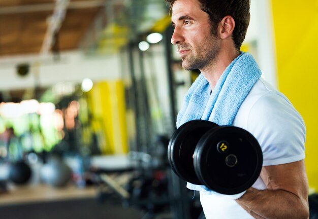 Vita sana e concetto di esercizio in palestra. Giovane in forma che si allena nel fitness club sportivo