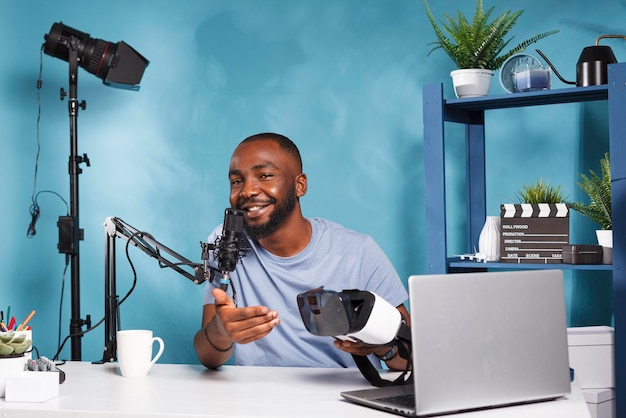 Vlogger che consiglia occhiali VR per un'esperienza coinvolgente e registra video per il canale Internet. Recensione di cuffie per realtà virtuale in streaming live di influencer allegro per gli abbonati
