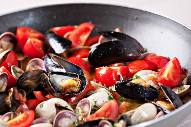 Vongole Frutti di mare Vongole con pomodoro e prezzemolo in padella