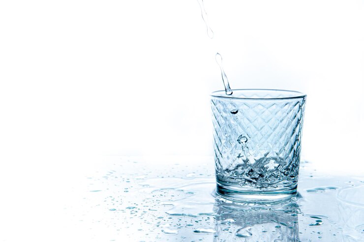 Water splashing from glass isolated on white background isolated
