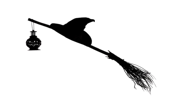 Photo witch hat and broom isolated on white background