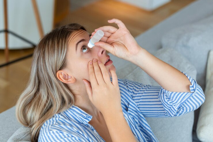 Woman using eye drop woman dropping eye lubricant to treat dry eye or allergy sick woman treating eyeball irritation or inflammation woman suffering from irritated eye optical symptoms