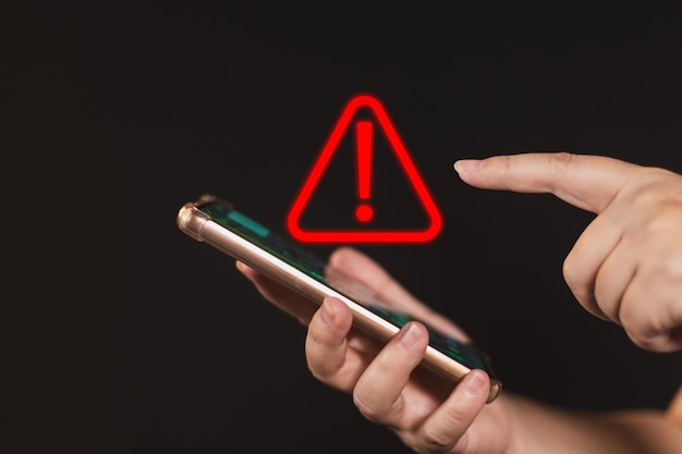 woman using smartphone with notification error warning sign over on mobile phone maintenance connection application programmer developer security network dangerous