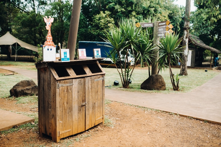 Photo wooden trash can for collecting separately plastic, cardboard and organic products in a park on the island of mauritius.