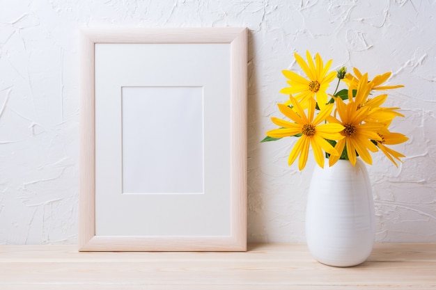 Wooden white frame mockup with yellow rosinweed flowers