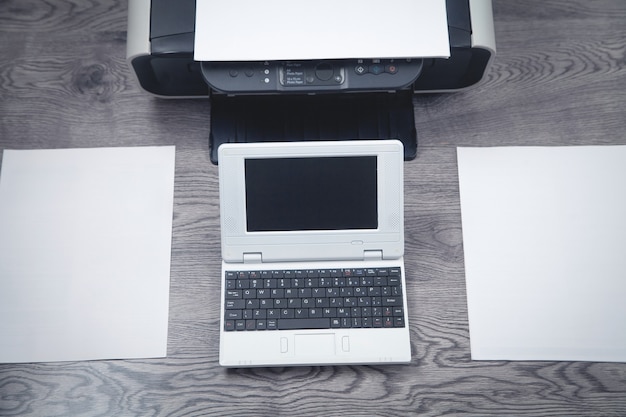 Xerox printer machine, laptop and papers on the desk.